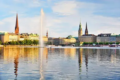 Panoramic view of Binnenalster (Inner Alster Lake) with Jungfernstieg and Rathaus in the background at sunset, Germany