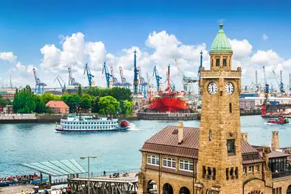 Famous Hamburger Landungsbruecken with harbor and traditional paddle steamer on Elbe river, St. Pauli district, Hamburg, Germany